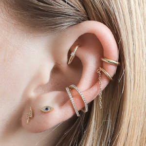 Large ear with multiple piercings wearing products from the Maison Miru Ear Bar