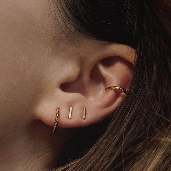 Little Bar Nap Earrings in Gold on model